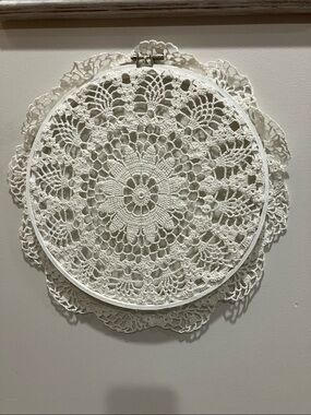 Hand crocheted doily in a decorative wall hoop. 11-1/2” across.